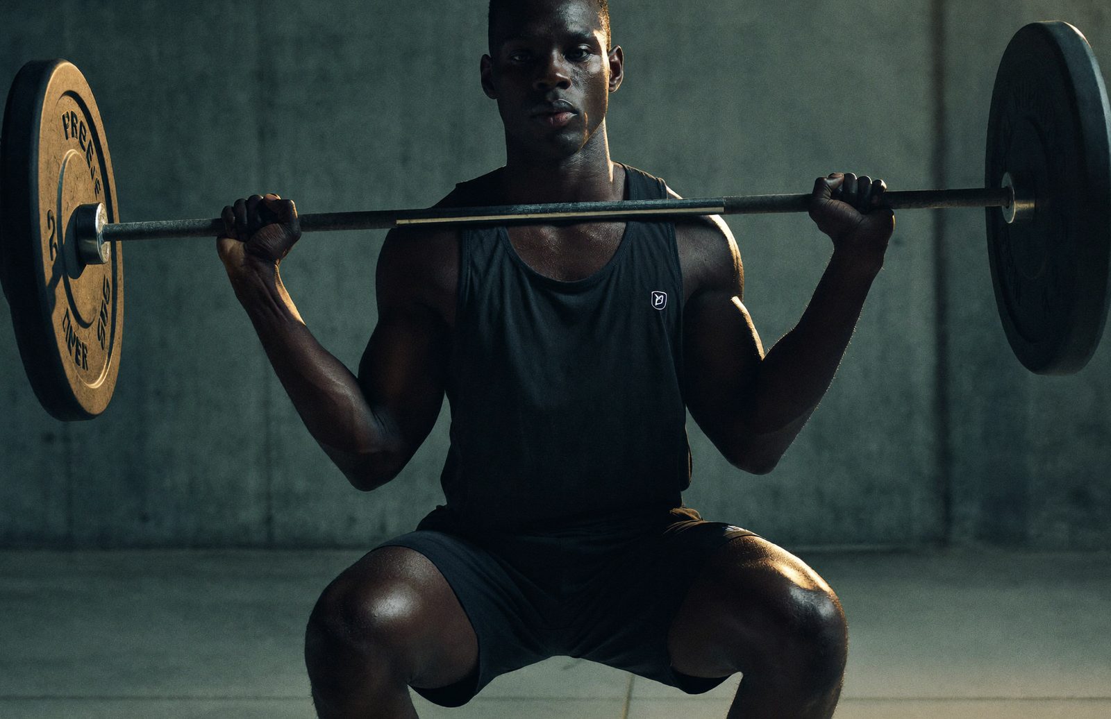 Athlete mid barbell squat